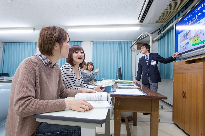 水原自動車学校で学科教習中の女性と指導員